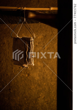 A cloth hanging in front of the clay wall 77403782