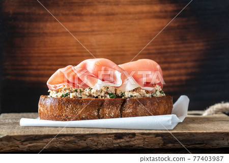 Bruschetta with cream cheese and prosciutto 77403987