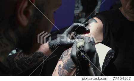 Photo of doing black tattoo of snake for woman 77404167