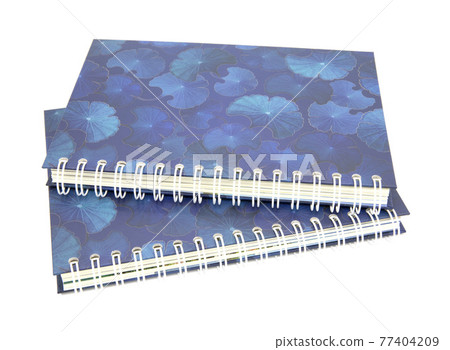 Blue spiral notebook with lotus leaves pattern on cover isolated on white background Blue spiral notebook with lotus leaves pattern on cover isolated on white background 77404209