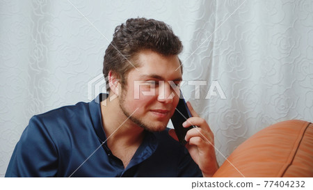 Photo of young man talking on the smartphone Photo of young man talking on the smartphone 77404232