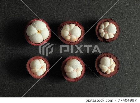 Mangosteen fruit (Garcinia mangostana) on dark background. 77404997