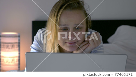 Woman spending leisure time with laptop and movie Woman spending leisure time with laptop and movie 77405171