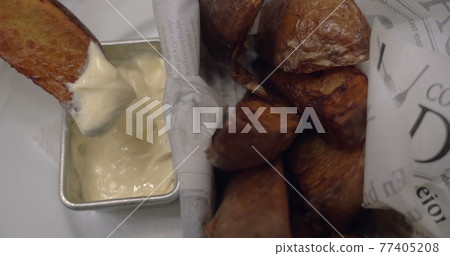 Eating baked potatoes with cream sauce 77405208
