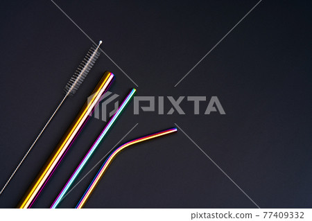 The modern trend caring for the environment. Self kit of reusable metal beverage straws of various diameters, colors and shapes with cleaning tool. On black background The modern trend caring for the environment. Self kit of reusable metal beverage straws of various diameters, colors and shapes with cleaning tool. On black background 77409332