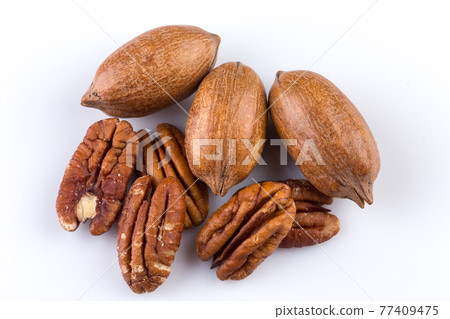 Few pecan nuts isolated on white Few pecan nuts isolated on white 77409475