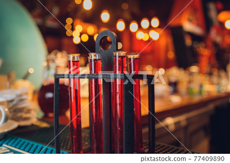 Laboratory glassware with alcohol cocktail's on chemical party. 77409890