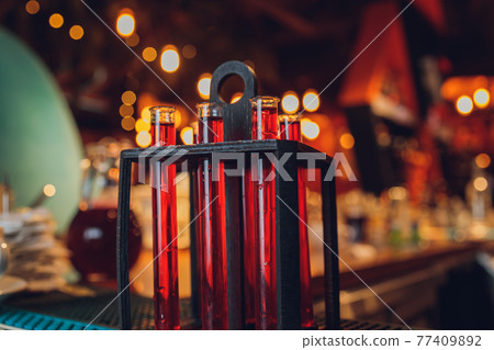 Laboratory glassware with alcohol cocktail's on chemical party. 77409892