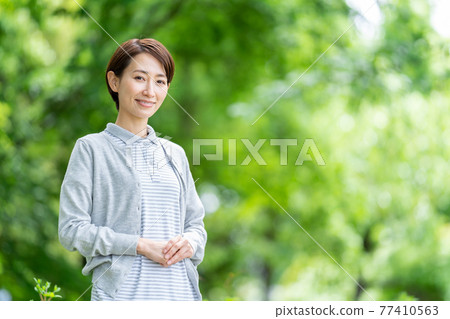 Caregiver outdoor fresh green background 77410563