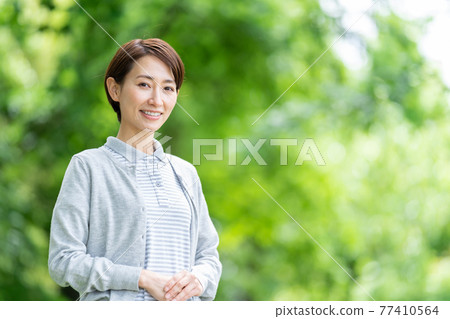 Caregiver outdoor fresh green background 77410564