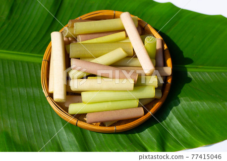 Lotus stems in bamboo basket on banana leaf 77415046