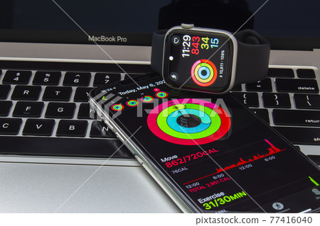 Calgary, Alberta Canada. May 7, 2021. An iPhone and an Apple Watch with the Fitness app. Calgary, Alberta Canada. May 7, 2021. An iPhone and an Apple Watch with the Fitness app. 77416040