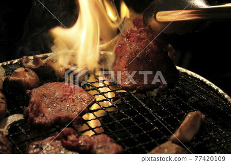 Roasting meat on a shichirin 77420109