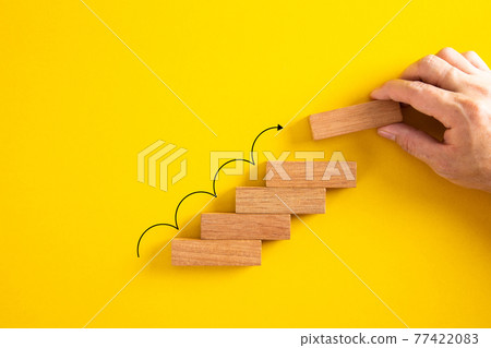 Hand arranging wood block stacking as stair stair with arrow up. Ladder career path for business growth success process concept Hand arranging wood block stacking as stair stair with arrow up. Ladder career path for business growth success process concept 77422083