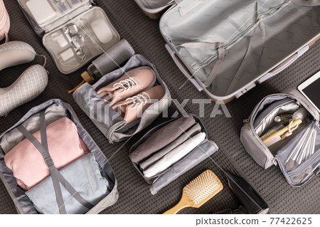 Organization of storage carrying necessary things in comfortable case with konmari method on bed 77422625