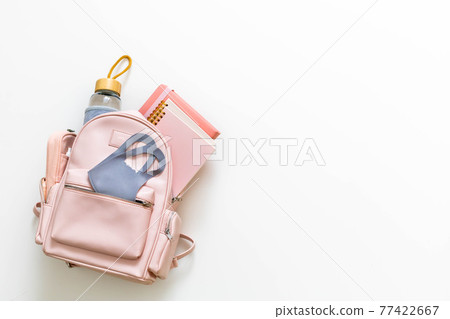 Top view elegant pink student backpack full of supplies isolated. Back to school concept Top view elegant pink student backpack full of supplies isolated. Back to school concept 77422667