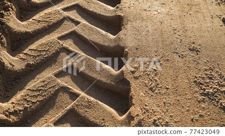 sand with tractor wheel tread on it sand with tractor wheel tread on it 77423049