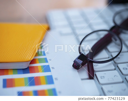 Business image · graph · keyboard · glasses · notebook · woman Business image · graph · keyboard · glasses · notebook · woman 77423129