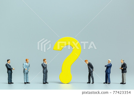 Businessman with big question. workers trying to solve the problem concept 77423354