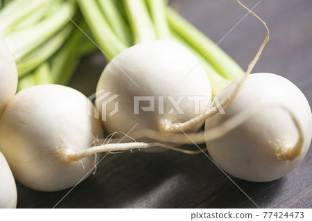 A bunch of turnips on a board A bunch of turnips on a board 77424473
