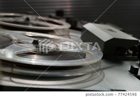 Old vintage reel-to-reel player. Tape recorder with spools. Bobbin tape recorder. 77424598