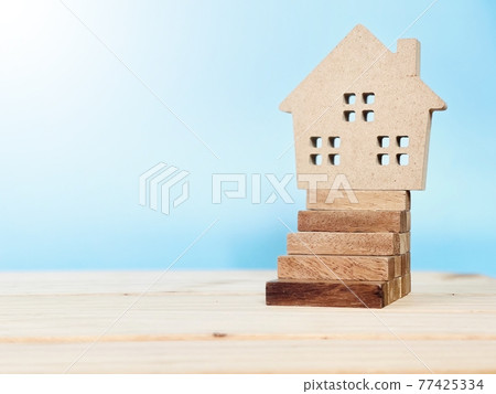 Business, finance, savings, money management, mortgage, property ladder or property loan concept : Wood house model on wood block stacking as step stair with copy space, ready for adding or mock up 77425334