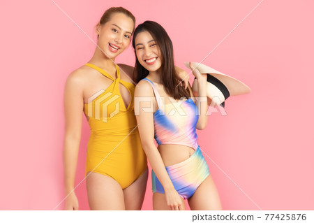 Beautiful, Sexy asian woman in bikini and smiling standing on pink background isolated .Summer vocation happy trip.She smiling and happy shopping bags. Beautiful, Sexy asian woman in bikini and smiling standing on pink background isolated .Summer vocation happy trip.She smiling and happy shopping bags. 77425876