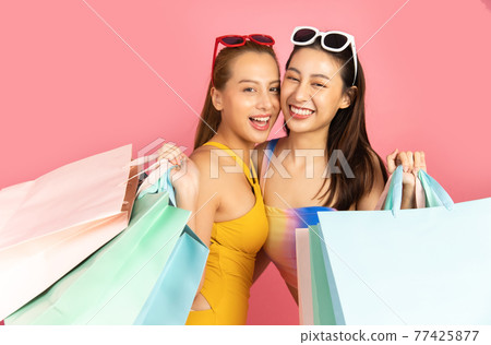 Beautiful, Sexy asian woman in bikini and smiling standing on pink background isolated .Summer vocation happy trip.She smiling and happy shopping bags. Beautiful, Sexy asian woman in bikini and smiling standing on pink background isolated .Summer vocation happy trip.She smiling and happy shopping bags. 77425877