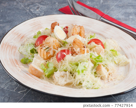 Caesar salad with prawns Parmesan and quail egg 77427914