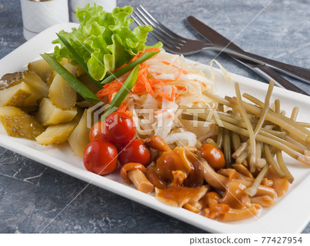 tasty assorted pickles: cucumbers, tomatoes, cabbage, mushrooms tasty assorted pickles: cucumbers, tomatoes, cabbage, mushrooms 77427954