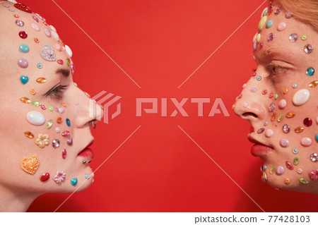 Womanly male with feminine features and masculine female with bald head looking at each other Womanly male with feminine features and masculine female with bald head looking at each other 77428103