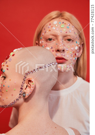 Bald unladylike female and albino feminine male looking at the different directions Bald unladylike female and albino feminine male looking at the different directions 77428115