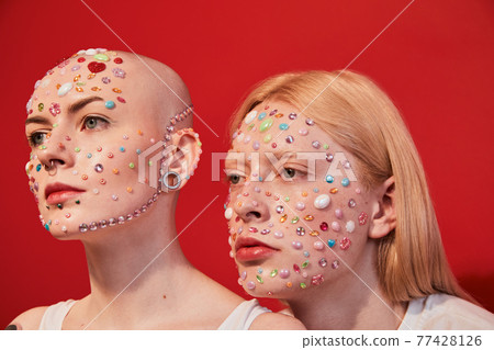 Womanly male with feminine features and masculine female with bald head looking away 77428126