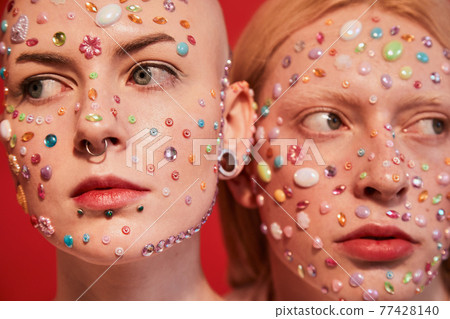 Bald unladylike female and albino feminine male looking at the different directions Bald unladylike female and albino feminine male looking at the different directions 77428140