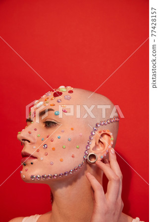 Bald woman with unladylike appearance looking away while posing Bald woman with unladylike appearance looking away while posing 77428157
