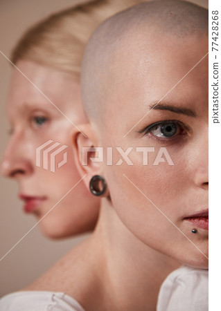 Masculine woman bonding to womanly long haired man while posing at the studio Masculine woman bonding to womanly long haired man while posing at the studio 77428268