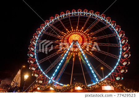 Illuminated Ferris Wheel at Christmas market in Berlin Germany 77429523