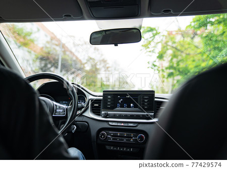 Interior of the car with a multimedia device on the dashboard. Interior of the car with a multimedia device on the dashboard. 77429574