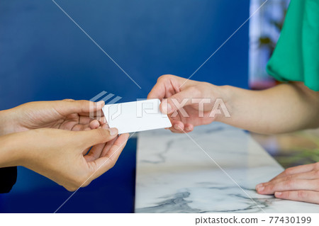 Close up woman hands reciving white plastic card. Close up woman hands reciving white plastic card. 77430199