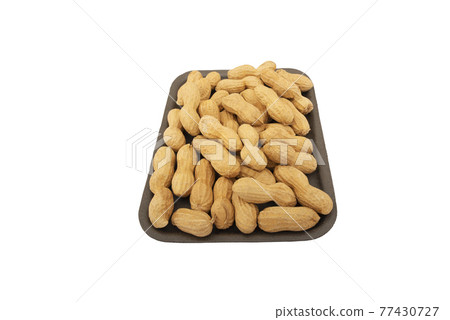 Unpeeled peanuts in a box isolated on white background 77430727