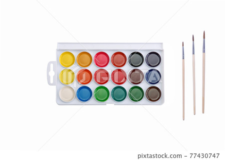 Multicolored aquarelle paints in paint box with brushes on white background. Multicolored aquarelle paints in paint box with brushes on white background. 77430747