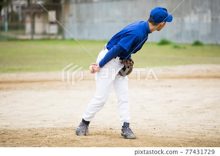 Men playing grass baseball 77431729