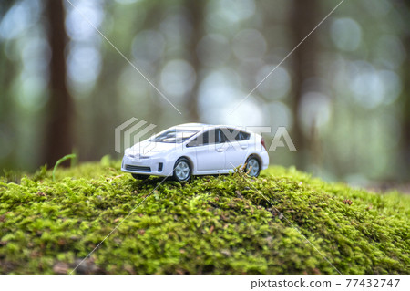 Miniature of a car placed in the forest Miniature of a car placed in the forest 77432747