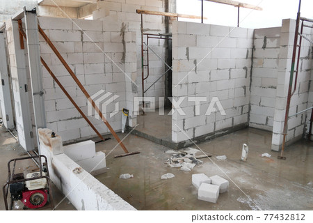 SEREMBAN, MALAYSIA -MARCH 19, 2021: Autoclaved aerated concrete block or known as AAC block used at the construction site. Install by workers using special mortar. Easy and fast. SEREMBAN, MALAYSIA -MARCH 19, 2021: Autoclaved aerated concrete block or known as AAC block used at the construction site. Install by workers using special mortar. Easy and fast. 77432812