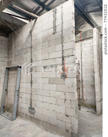 SEREMBAN, MALAYSIA -MARCH 19, 2021: Autoclaved aerated concrete block or known as AAC block used at the construction site. Install by workers using special mortar. Easy and fast.   77432818