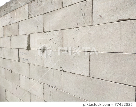 SEREMBAN, MALAYSIA -MARCH 19, 2021: Autoclaved aerated concrete block or known as AAC block used at the construction site. Install by workers using special mortar. Easy and fast. SEREMBAN, MALAYSIA -MARCH 19, 2021: Autoclaved aerated concrete block or known as AAC block used at the construction site. Install by workers using special mortar. Easy and fast. 77432825