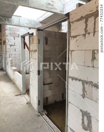 SEREMBAN, MALAYSIA -MARCH 19, 2021: Autoclaved aerated concrete block or known as AAC block used at the construction site. Install by workers using special mortar. Easy and fast. SEREMBAN, MALAYSIA -MARCH 19, 2021: Autoclaved aerated concrete block or known as AAC block used at the construction site. Install by workers using special mortar. Easy and fast. 77432834