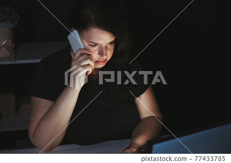 Woman making important call late in the night Woman making important call late in the night 77433785
