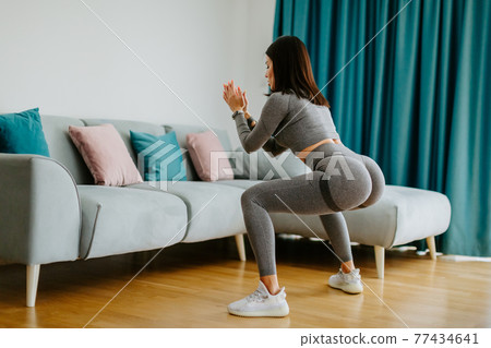 female butt workout squats at home. Fitness at home concept female butt workout squats at home. Fitness at home concept 77434641