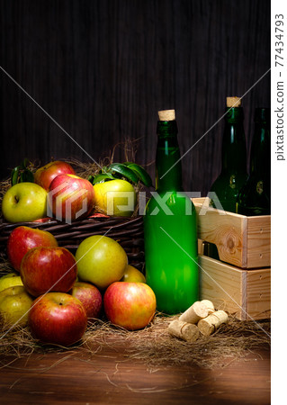 Asturian cider and apples on black background. 77434793